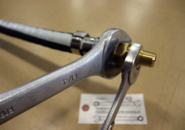 Tightening or loosening fittings on an induction power cable is a job for two wrenches